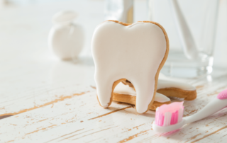 image of tooth shaped cookie next to a toothbrush